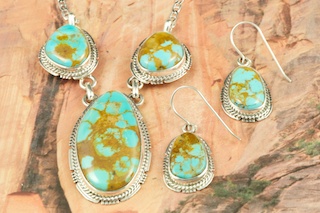 Genuine Manassa Turquoise set in Sterling Silver. Beautiful Necklace and Earrings Set. This Turquoise is also referred to as King�s Manassa Turquoise. The Manassa Turquoise mine is located in Manassa, Conejos County, Colorado. Created by Navajo Artist Kathy Yazzie. Signed by the artist.